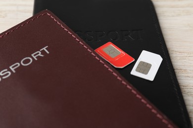 Passports and SIM cards on table, closeup