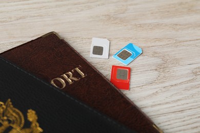 Passports and SIM cards on wooden table