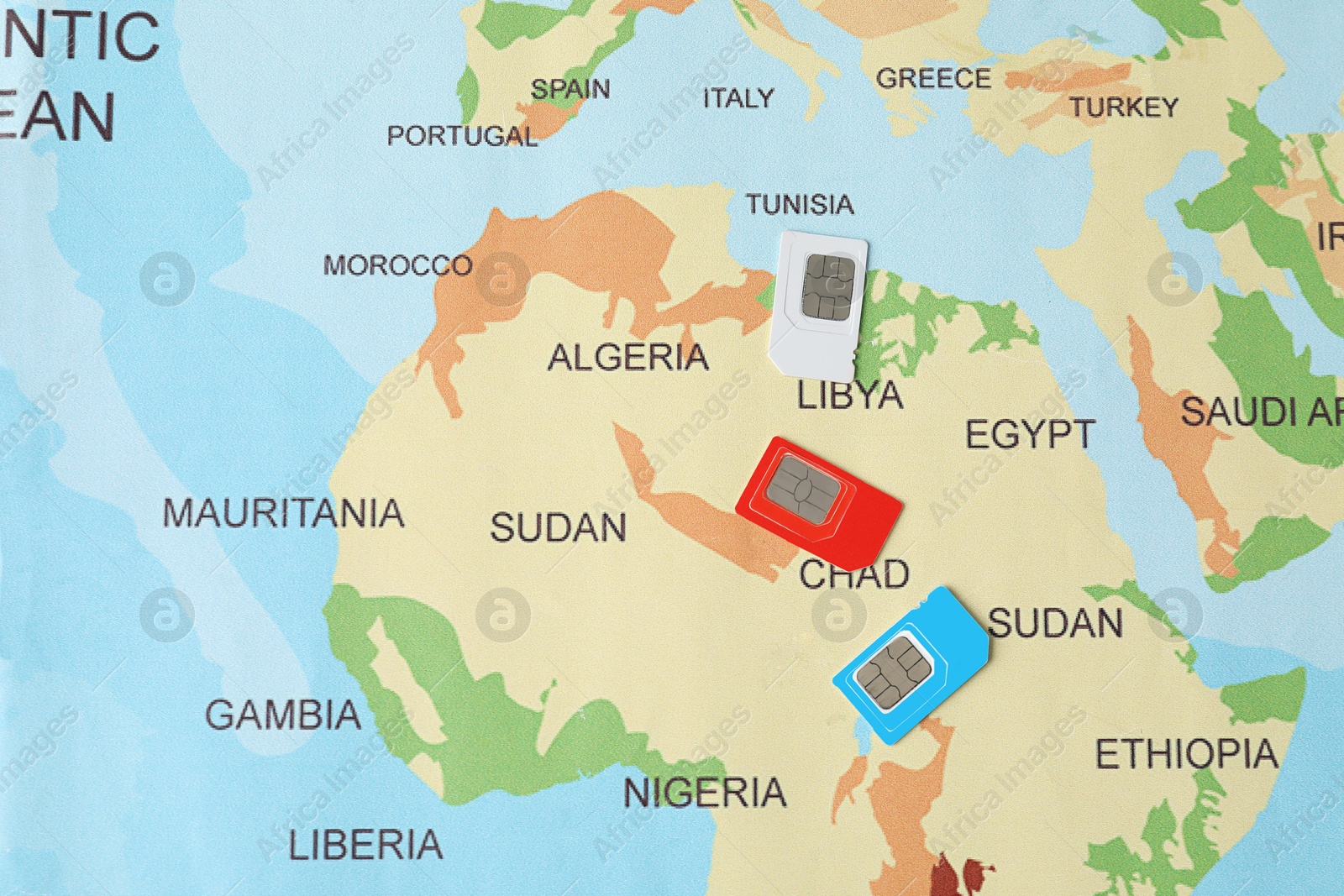 Photo of Group of SIM cards on world map, flat lay