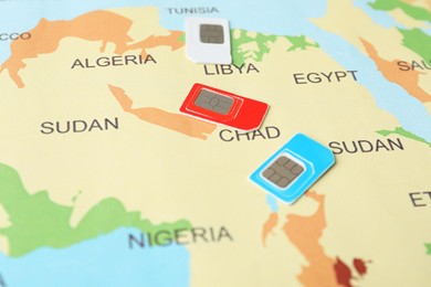 Group of SIM cards on world map, closeup