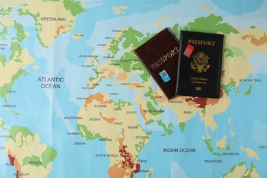 SIM cards and passports on world map, flat lay