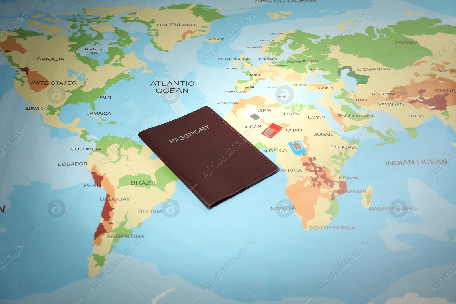 Photo of Modern SIM cards and passport on world map