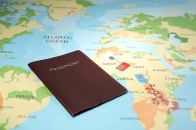 Photo of Modern SIM cards and passport on world map