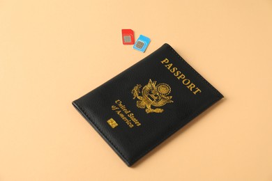 Photo of Modern SIM cards and passport on beige background