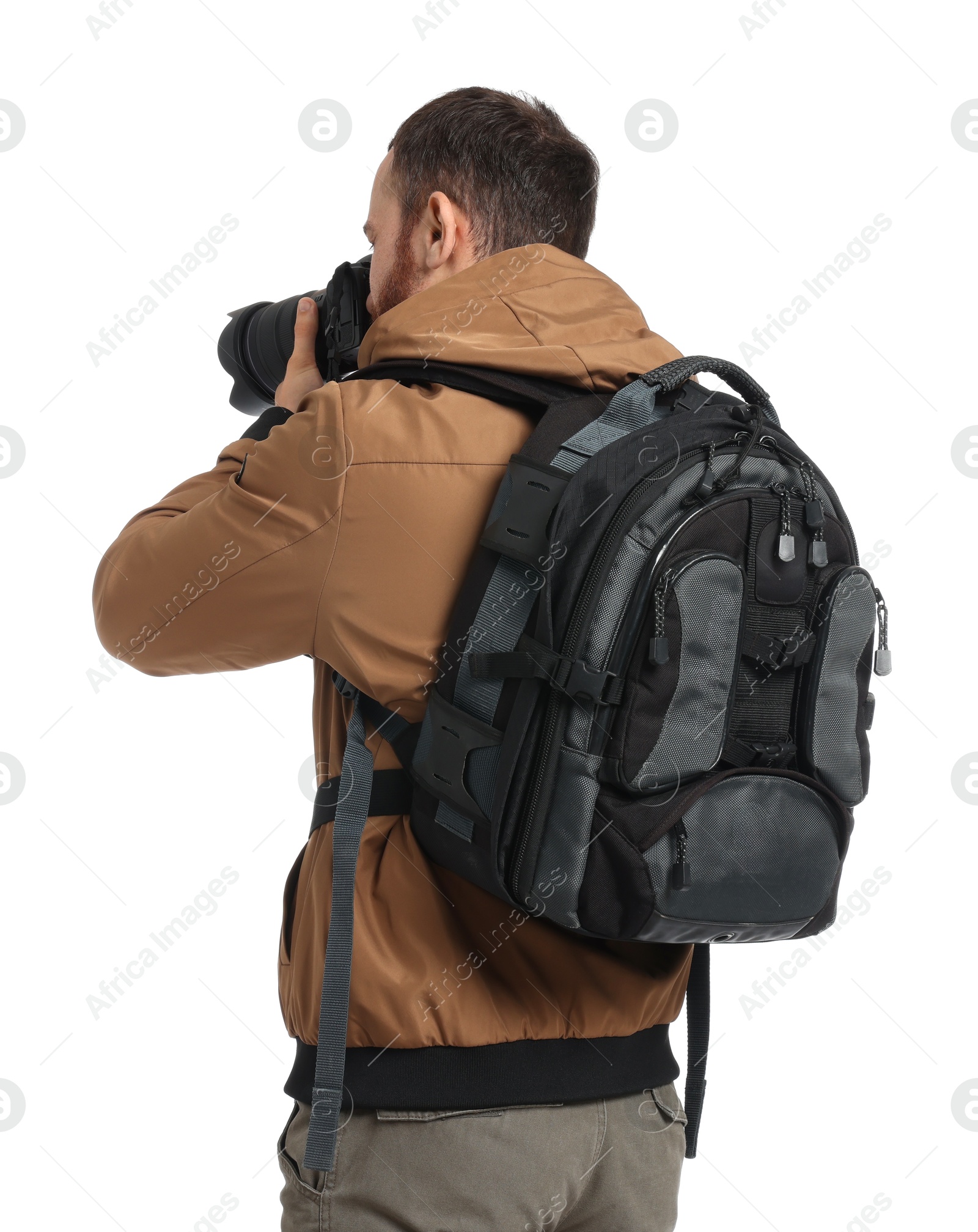 Photo of Photographer with backpack and camera taking picture on white background, back view