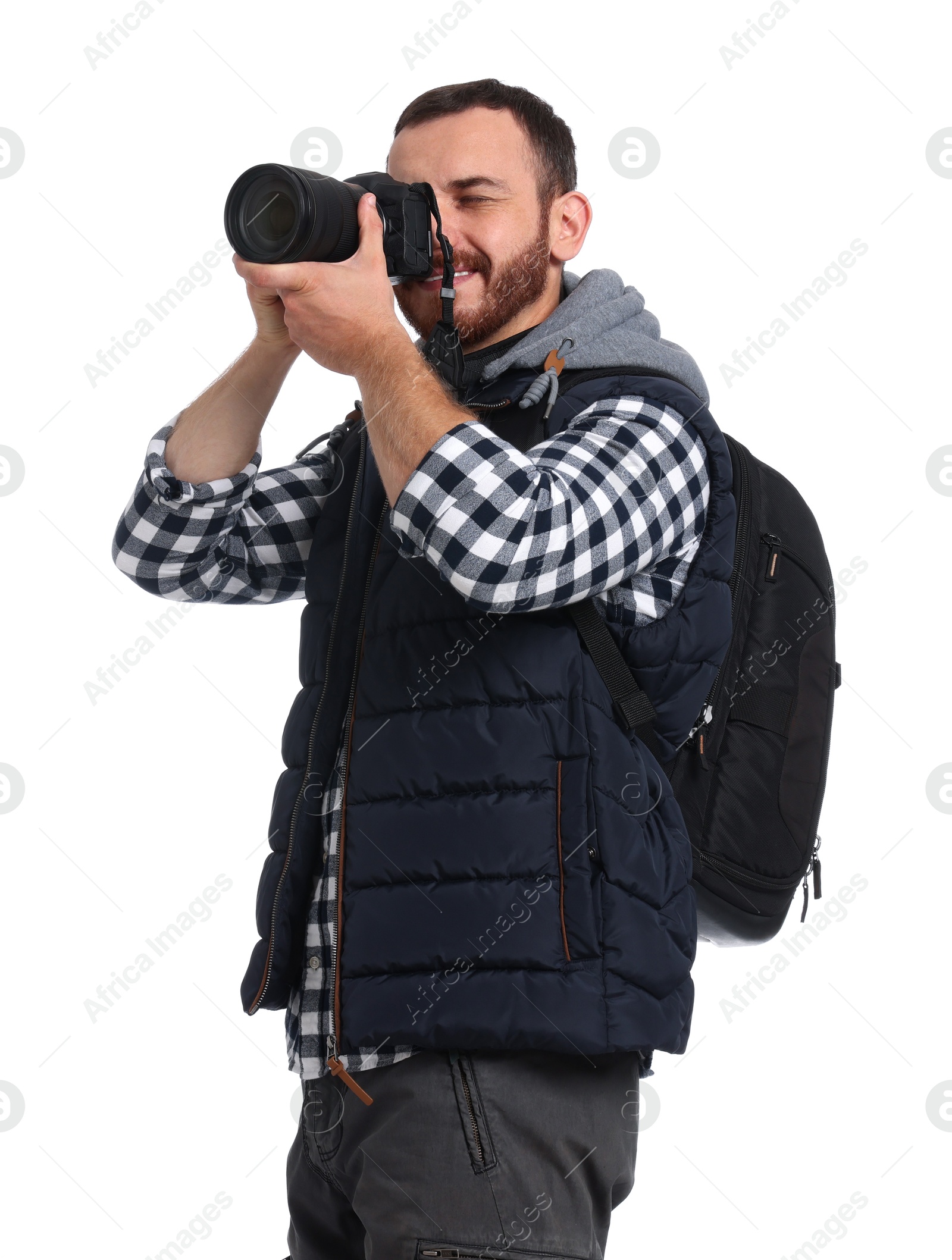 Photo of Photographer with backpack and camera taking picture on white background