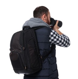 Photo of Photographer with backpack and camera taking picture on white background, back view