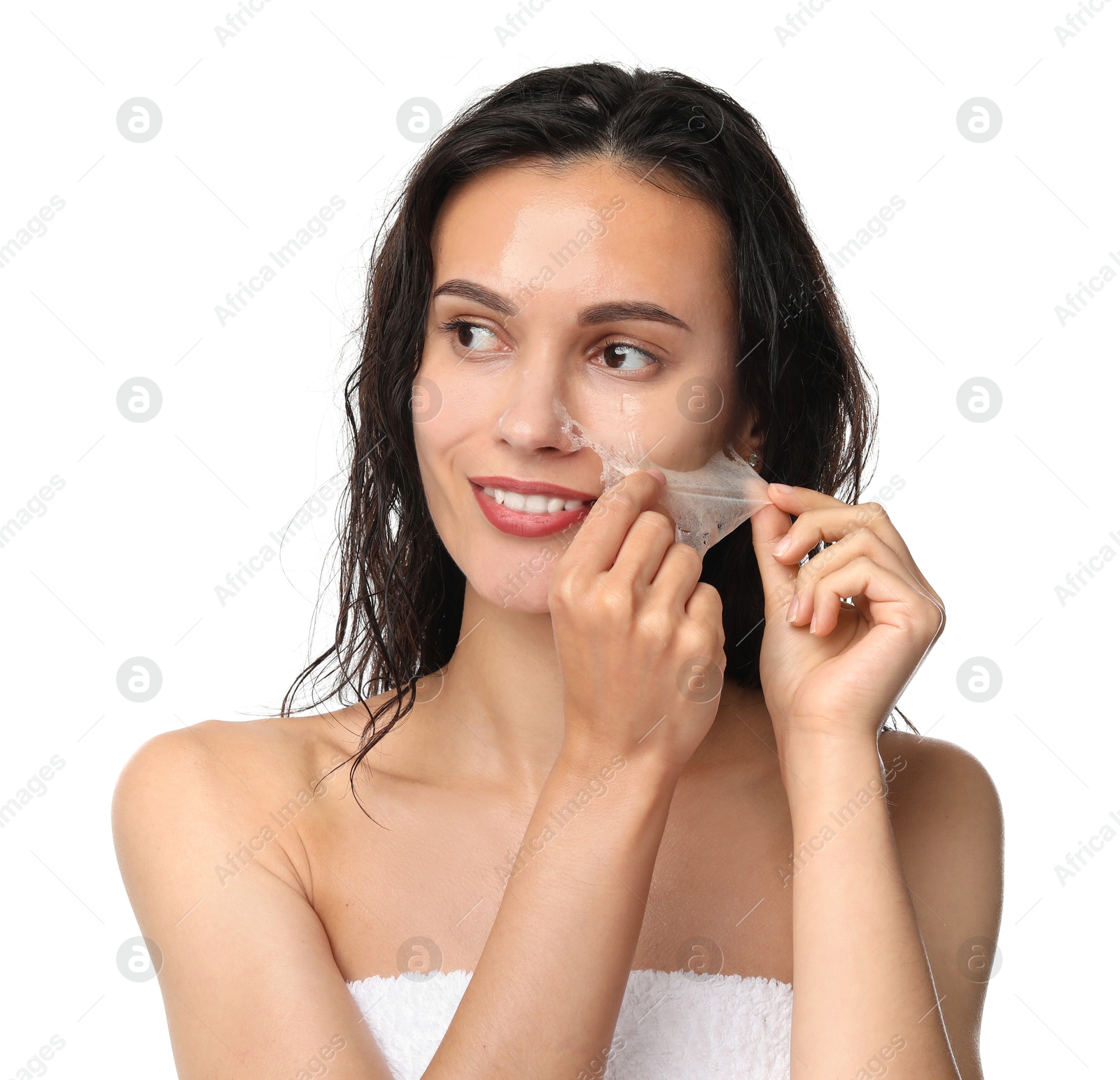 Photo of Smiling woman peeling off face mask on white background