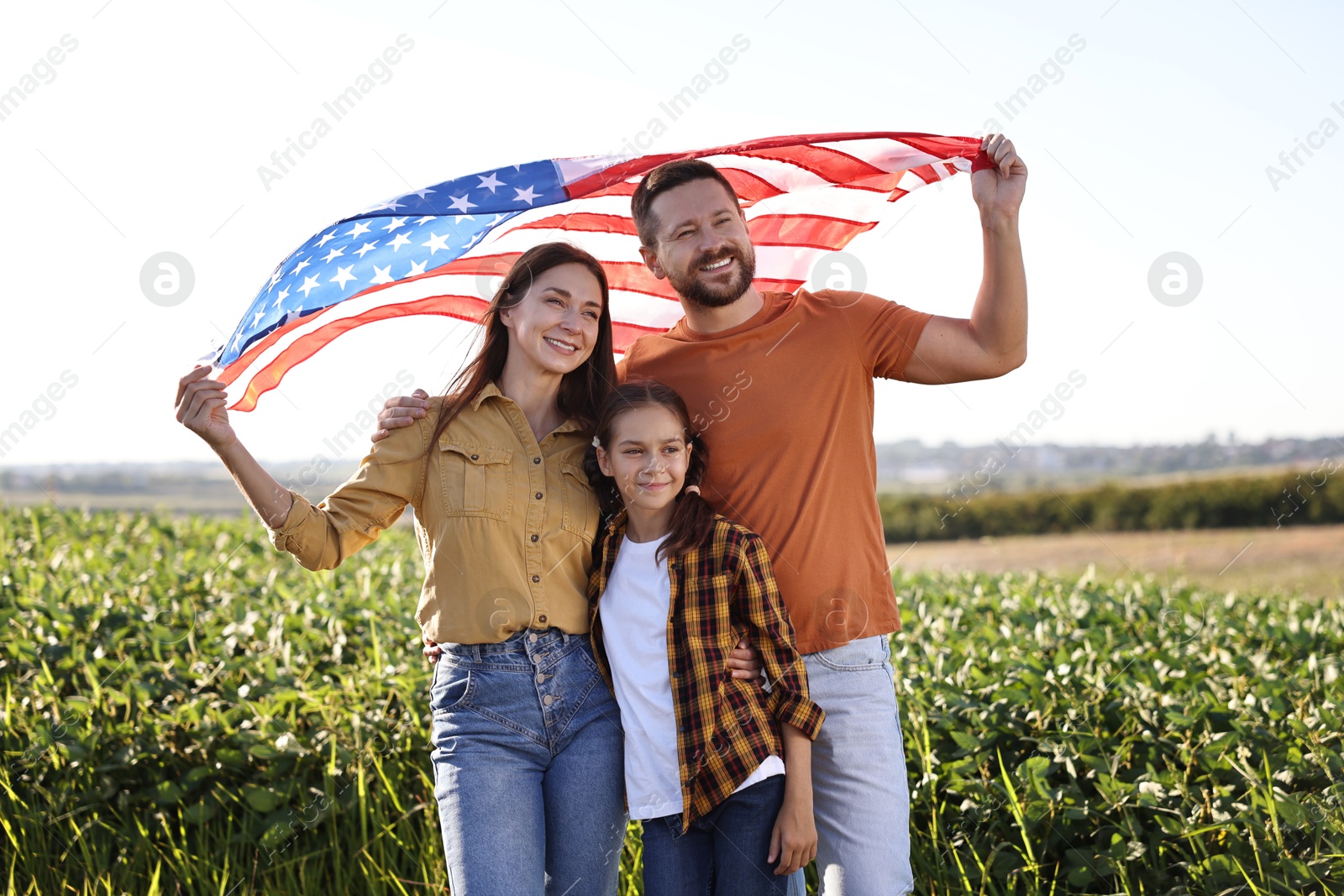 Photo of Happy family with flag of USA outdoors