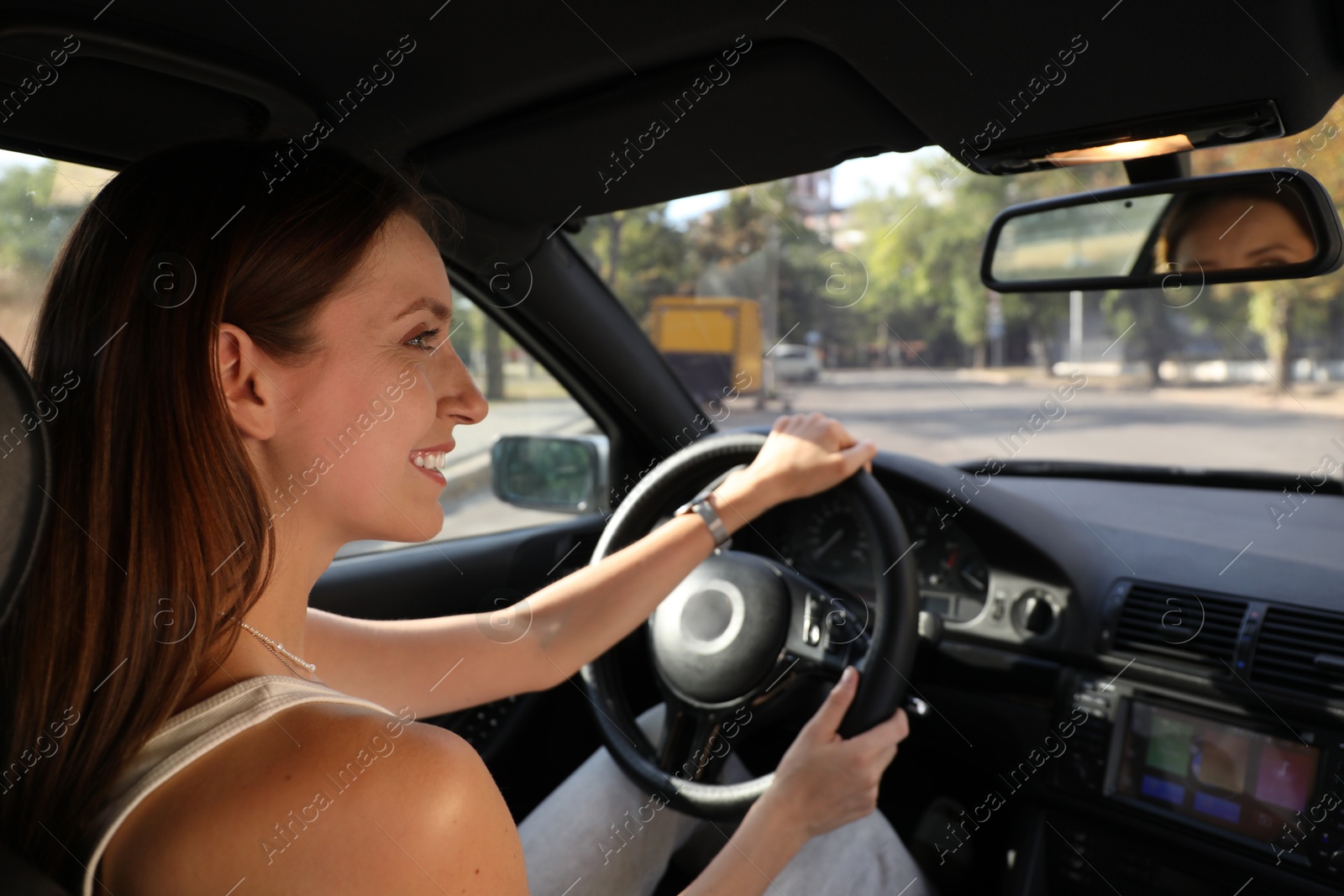 Photo of Woman holding steering wheel while driving car