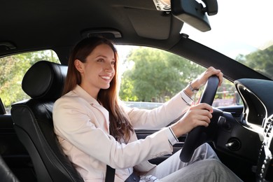 Woman holding steering wheel while driving car