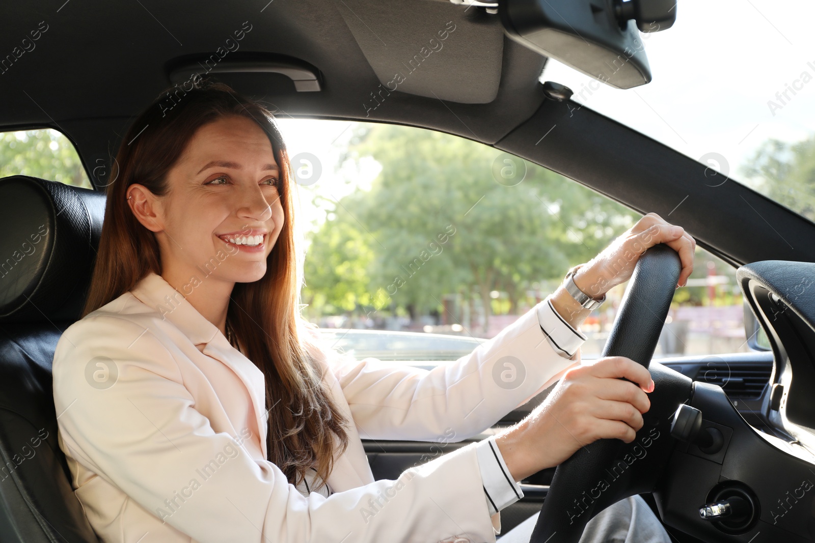 Photo of Woman holding steering wheel while driving car