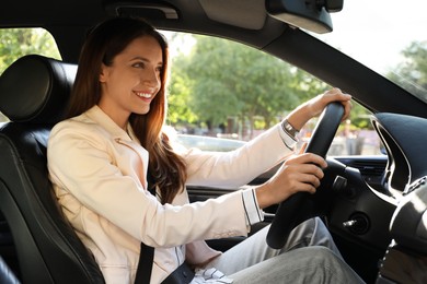 Woman holding steering wheel while driving car