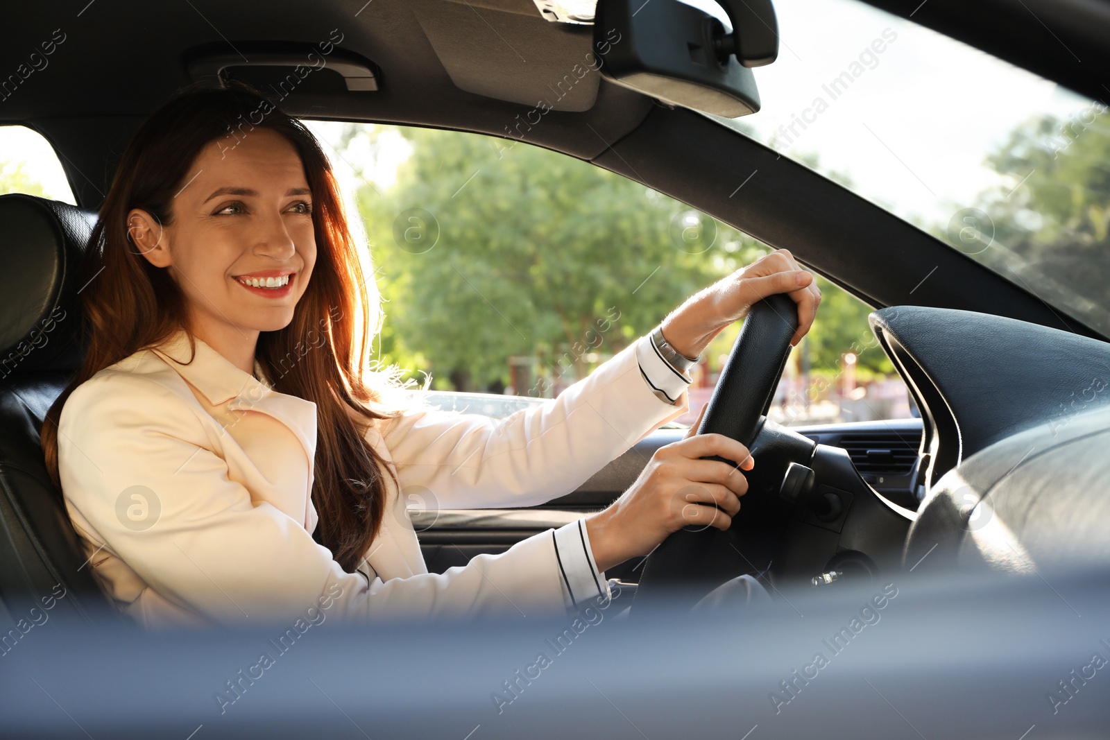 Photo of Woman holding steering wheel while driving car