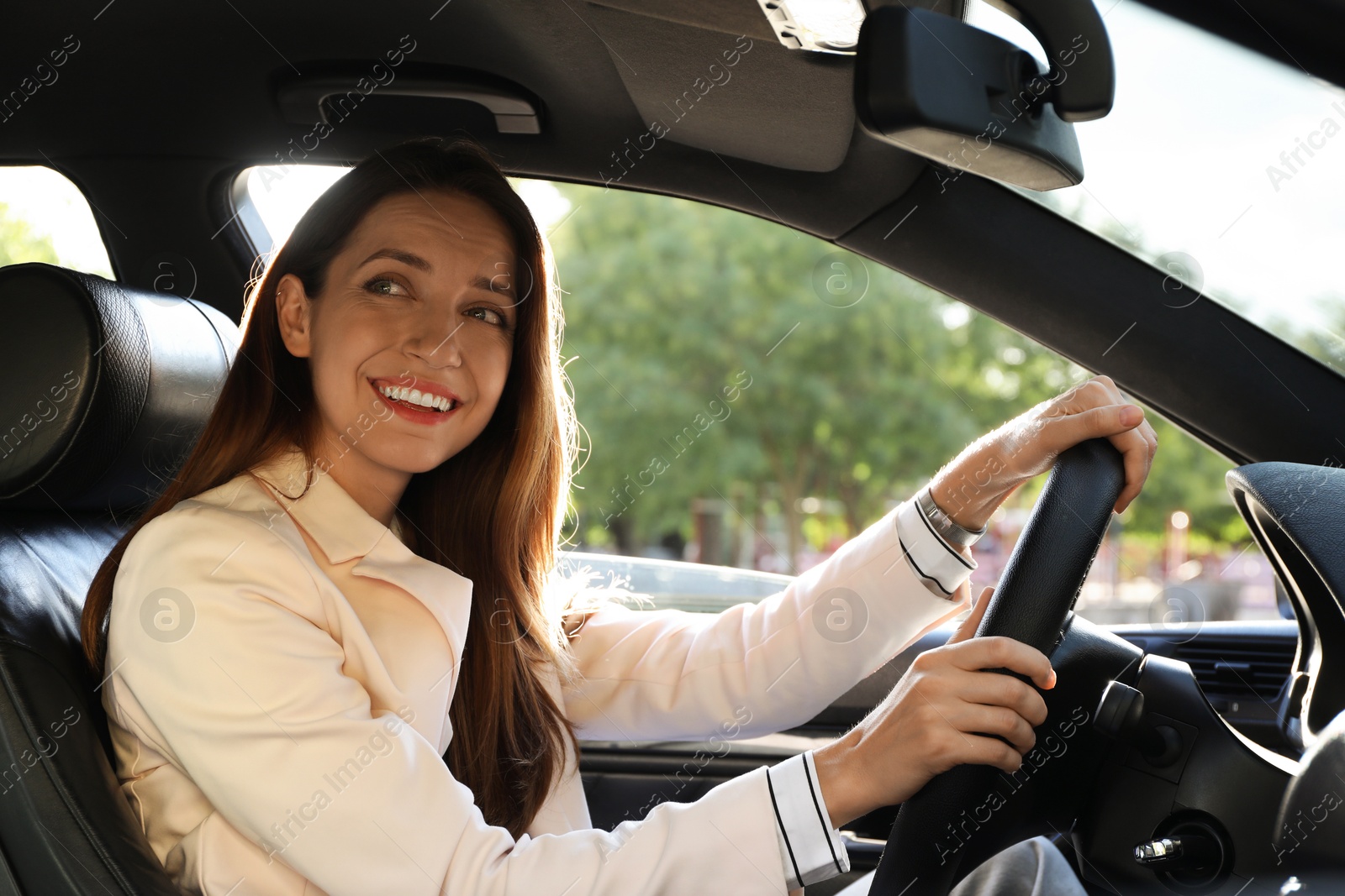 Photo of Woman holding steering wheel while driving car