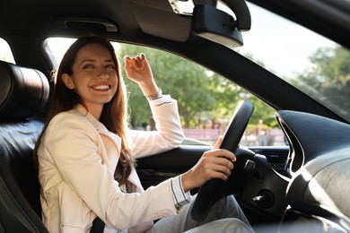 Woman holding steering wheel while driving car