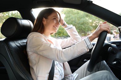 Photo of Woman holding steering wheel while driving car