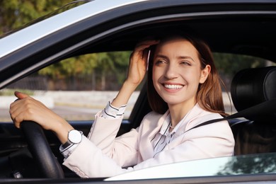 Woman holding steering wheel while driving car