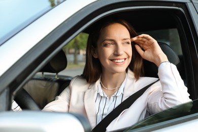 Woman holding steering wheel while driving car