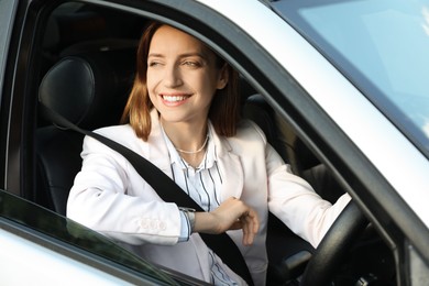 Woman holding steering wheel while driving car