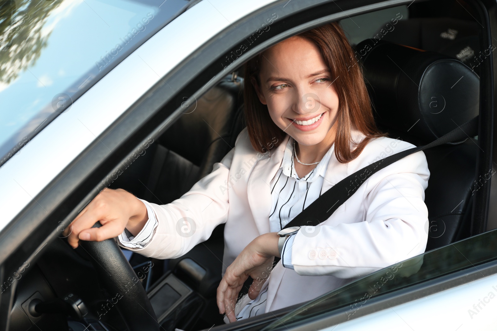 Photo of Woman holding steering wheel while driving car