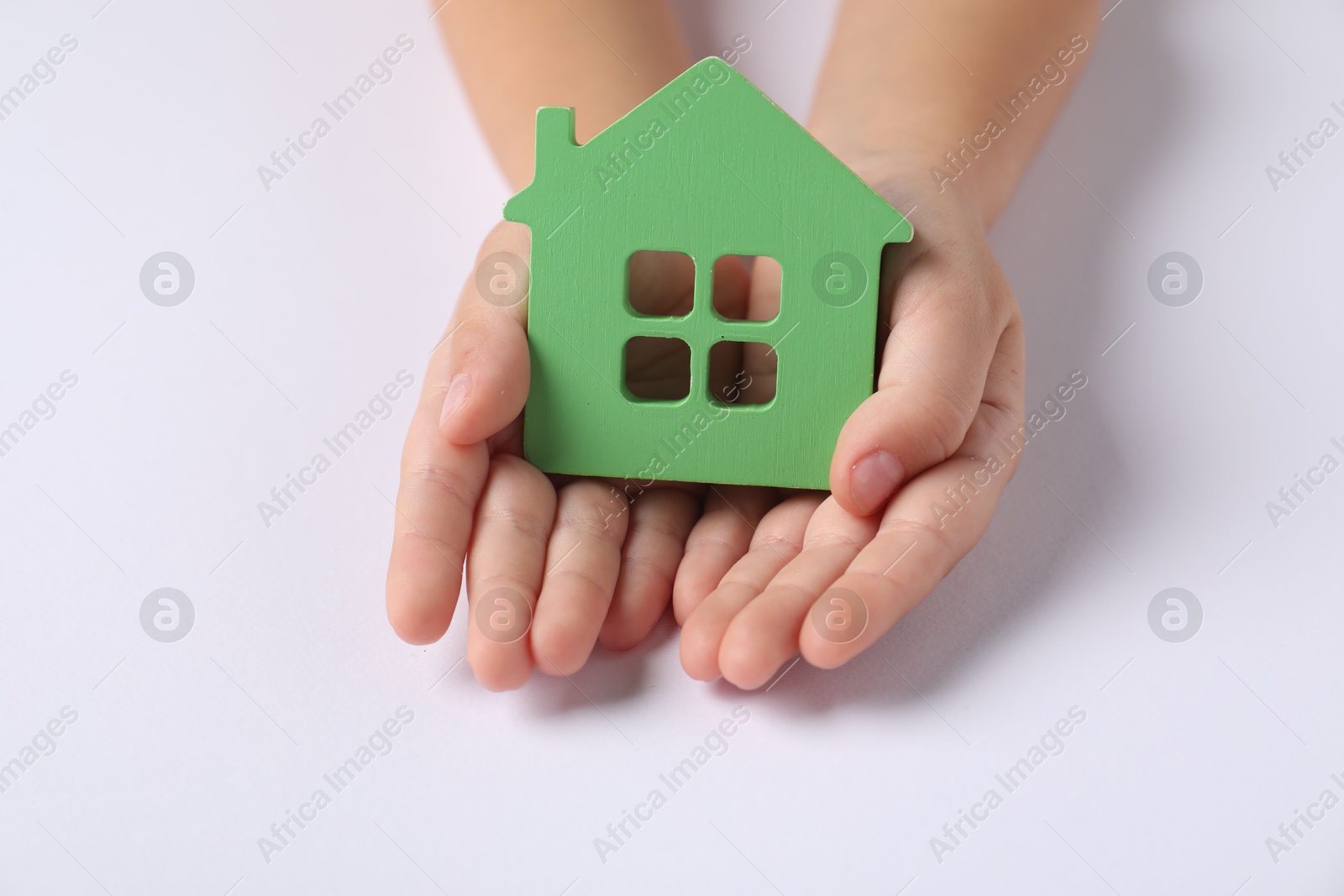 Photo of Adoption concept. Kid with cutout of house at white table, closeup