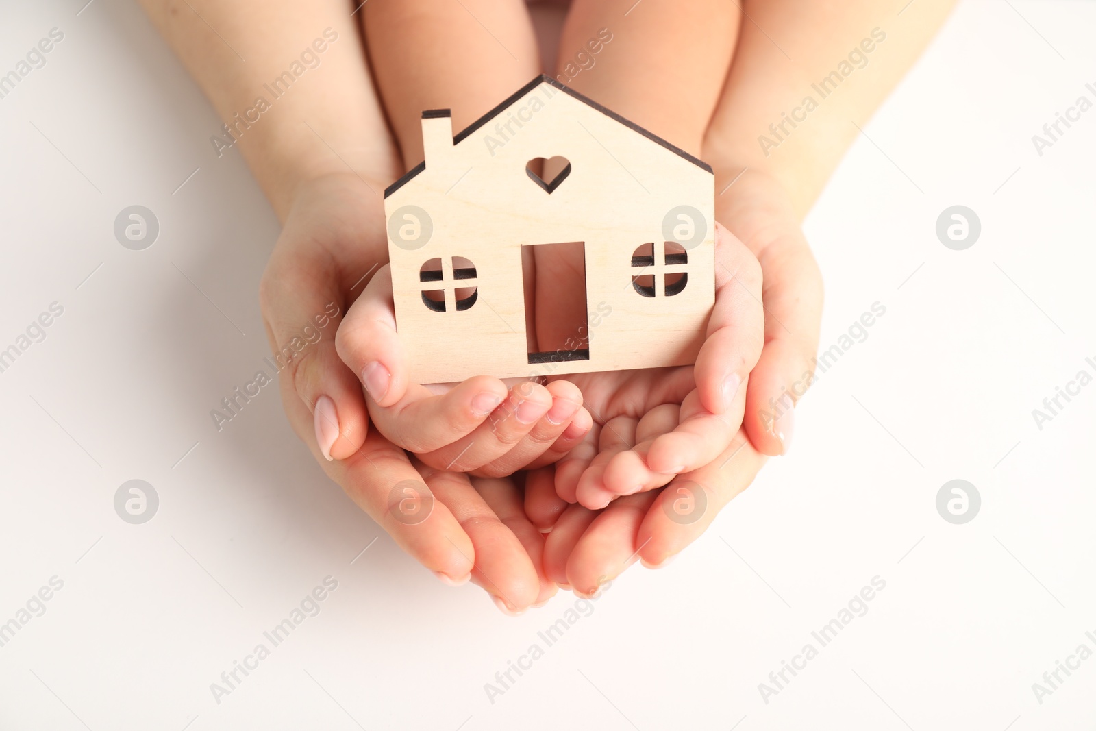 Photo of Adoption concept. Woman and kid with cutout of house at white background, closeup