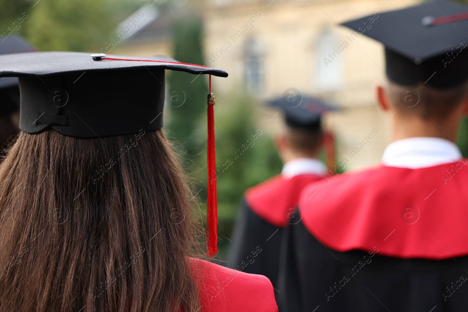 Photo of Students at graduation ceremony outdoors, back view