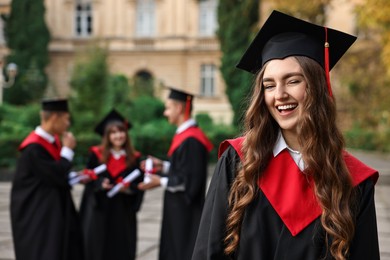 Photo of Graduation ceremony. Happy students outdoors, selective focus