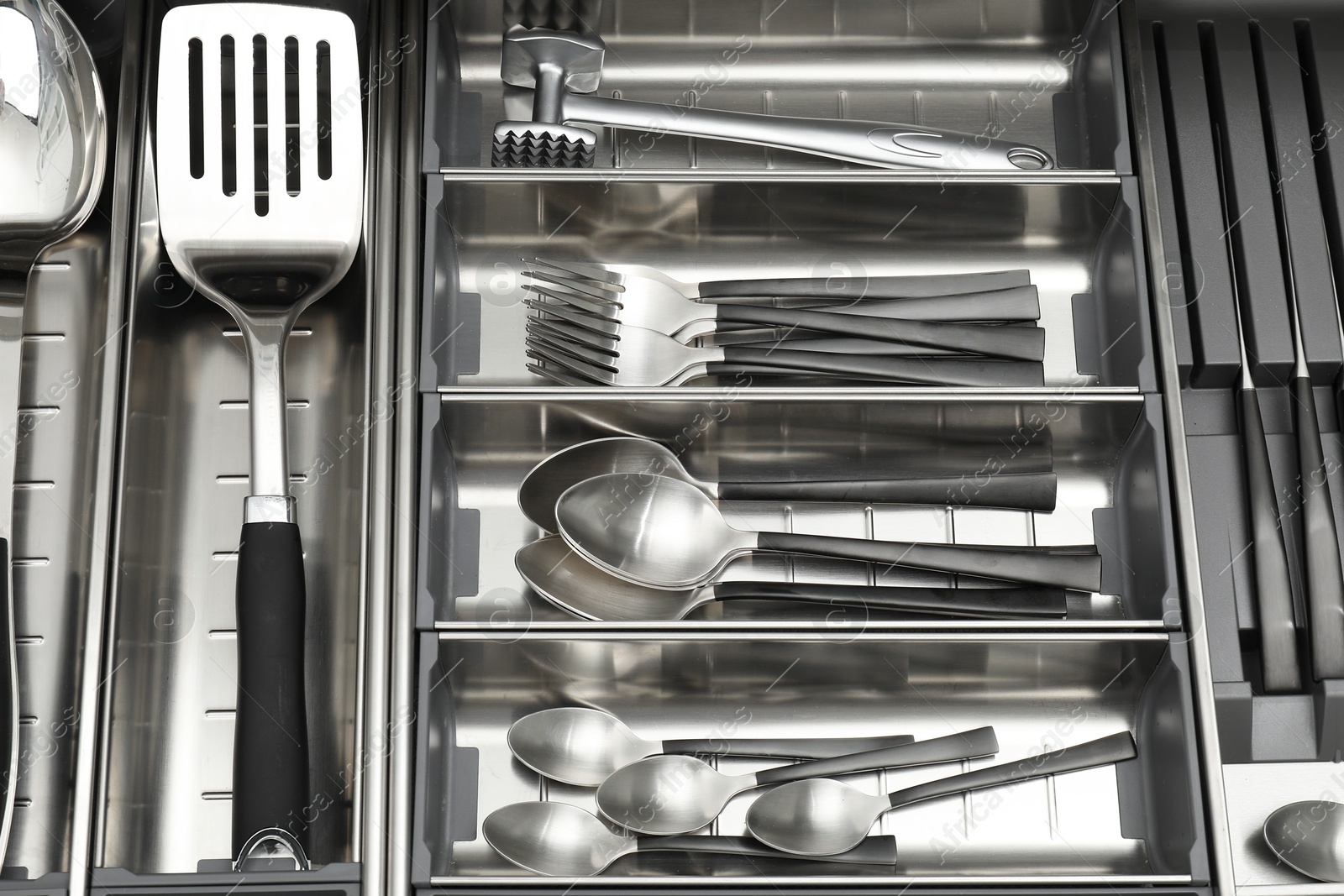 Photo of Cutlery in box, top view. Kitchen utensils storage