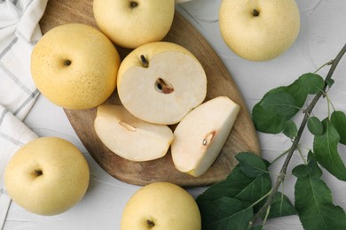 Photo of Delicious fresh apple pears and green leaves on white table, top view