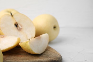 Delicious fresh apple pears on white table, closeup. Space for text