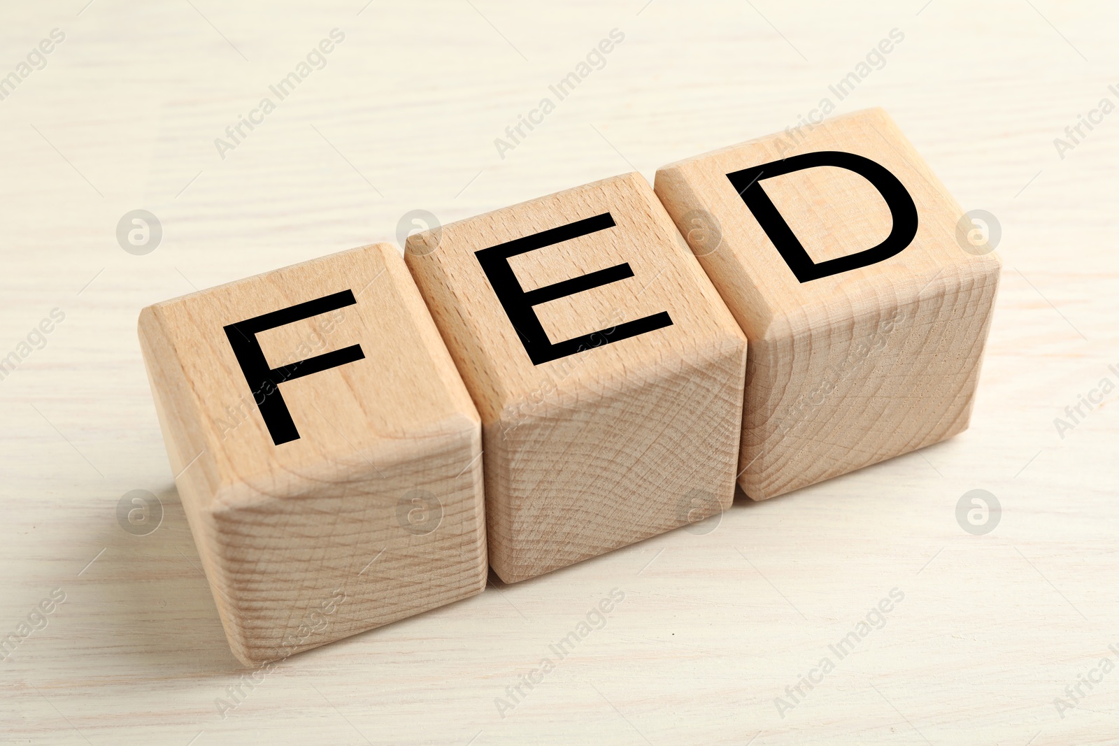 Photo of Wooden cubes with letters Fed (Federal Reserve System) on table