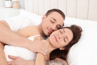 Photo of Cute couple napping on bed at home