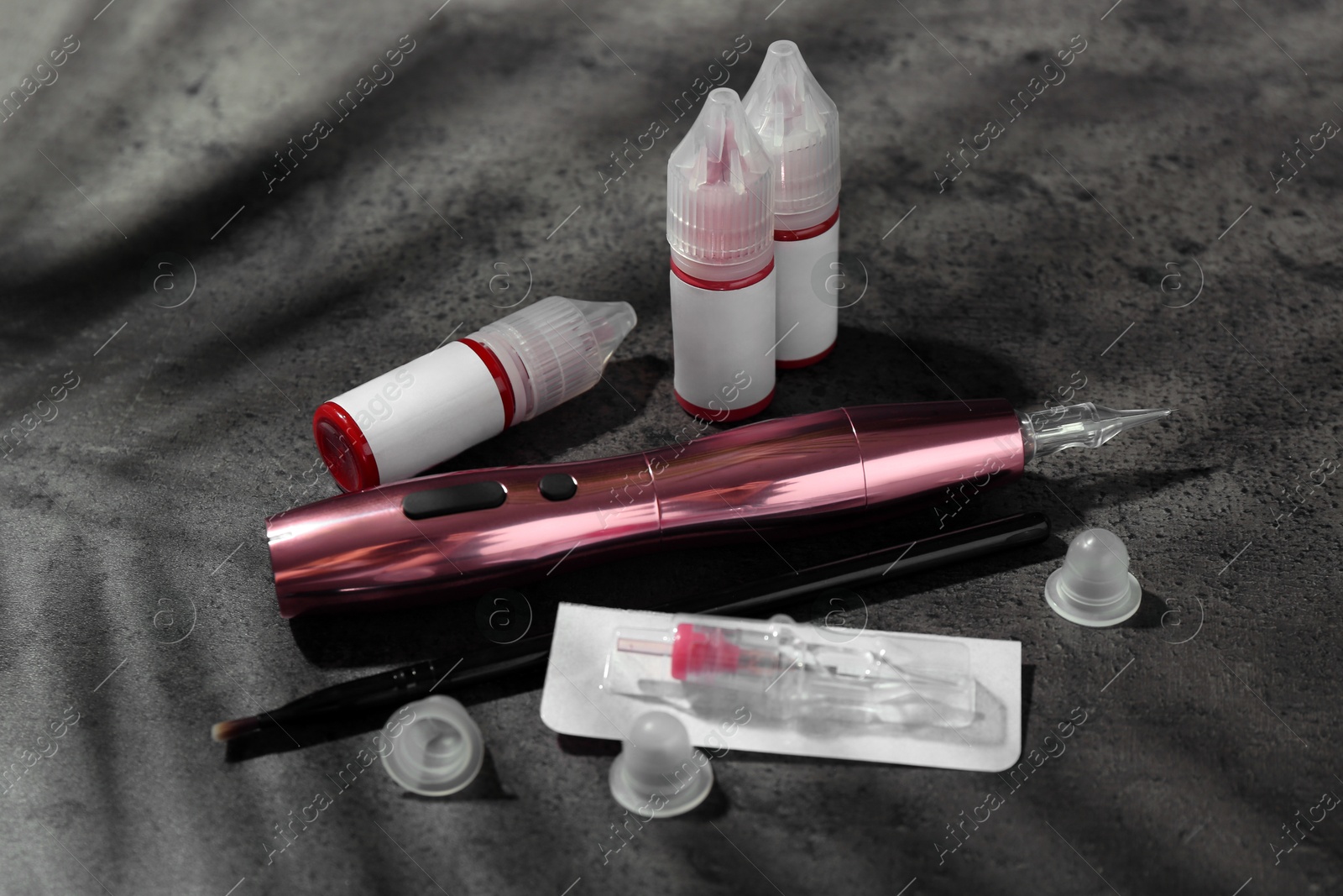 Photo of Permanent makeup equipment kit on grey table