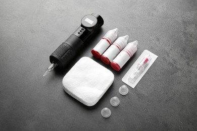 Permanent makeup equipment kit on grey table