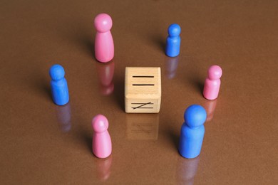 Gender equality concept. Male and female figures on brown background, above view