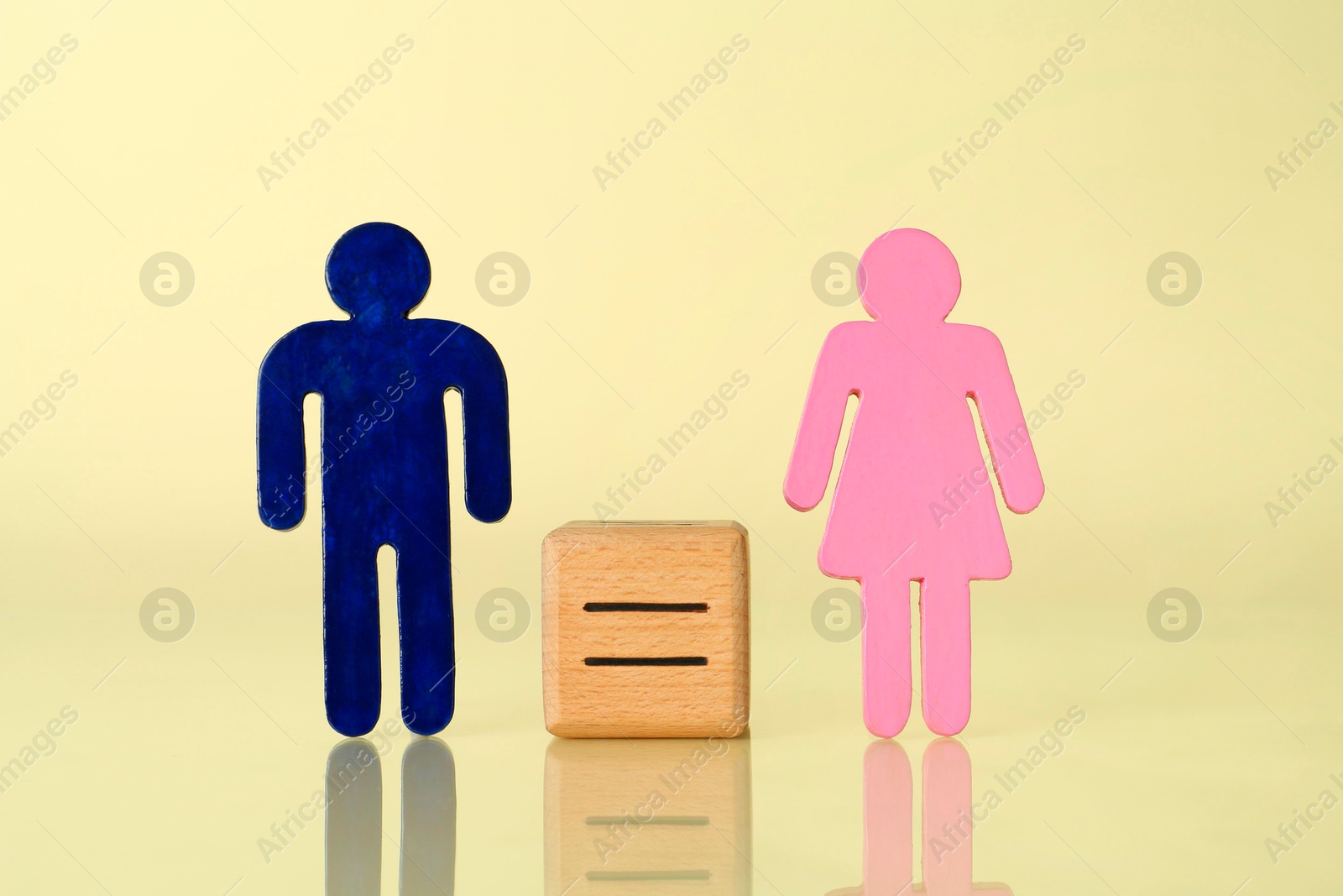 Photo of Gender equality concept. Male and female figures on light yellow background