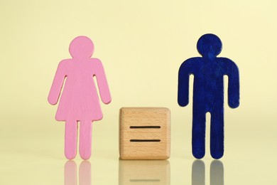 Photo of Gender equality concept. Male and female figures on light yellow background