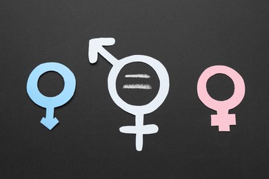 Photo of Equality concept. Male and female gender signs on chalkboard, flat lay