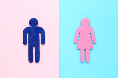 Gender equality concept. Male and female figures on color background, flat lay