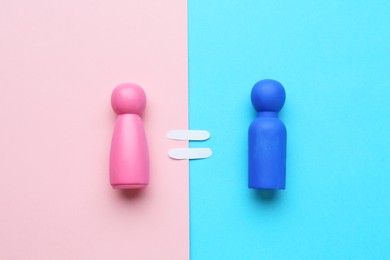 Photo of Gender equality concept. Male and female figures on color background, flat lay