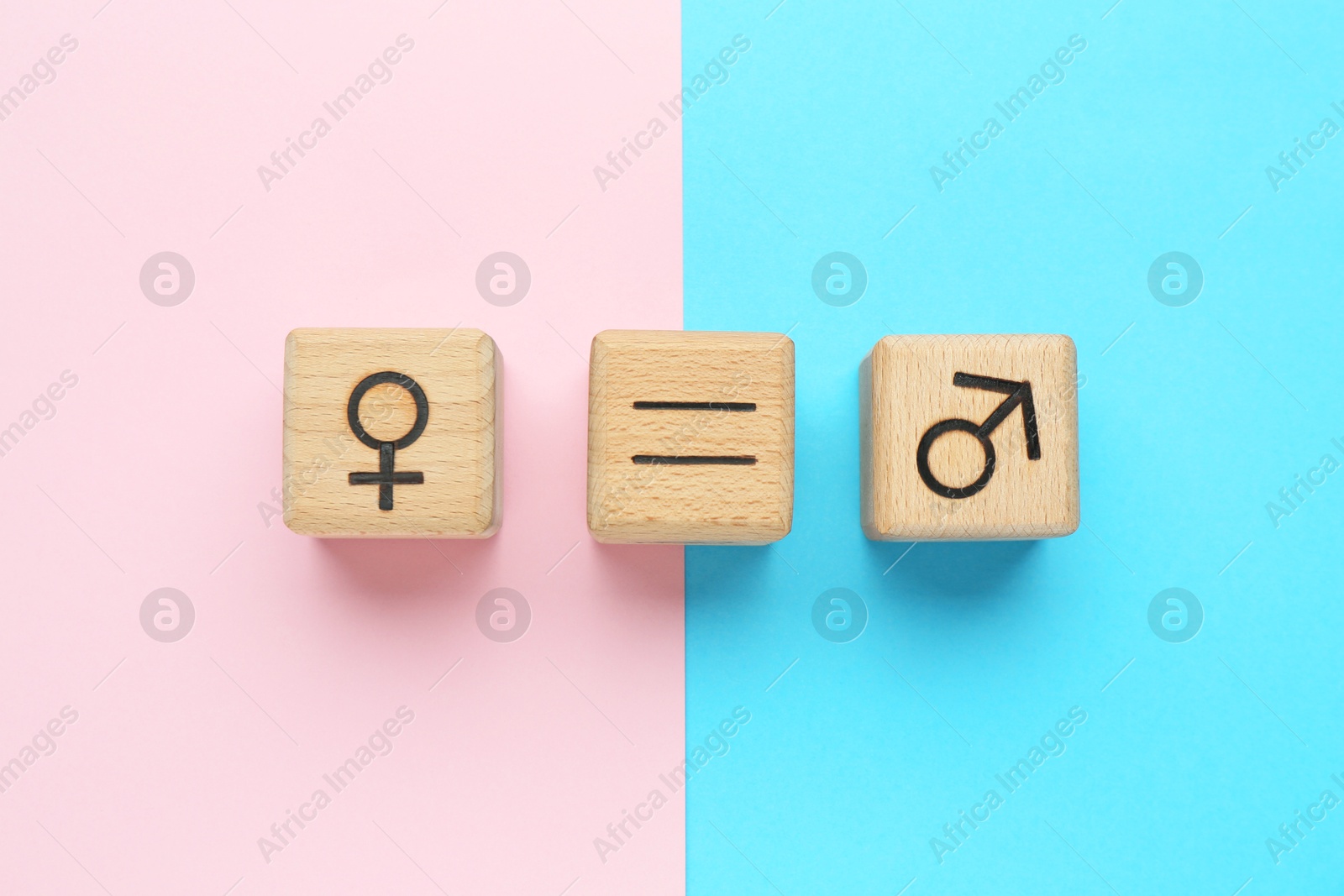 Photo of Gender equality concept. Wooden cubes with male and female symbols on color background, flat lay