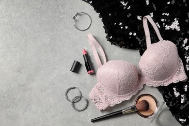 Photo of Beautiful lace bra and accessories on grey background, flat lay. Space for text