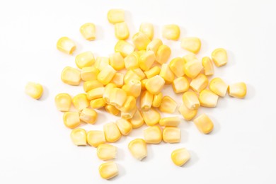 Pile of fresh corn kernels on white background, flat lay