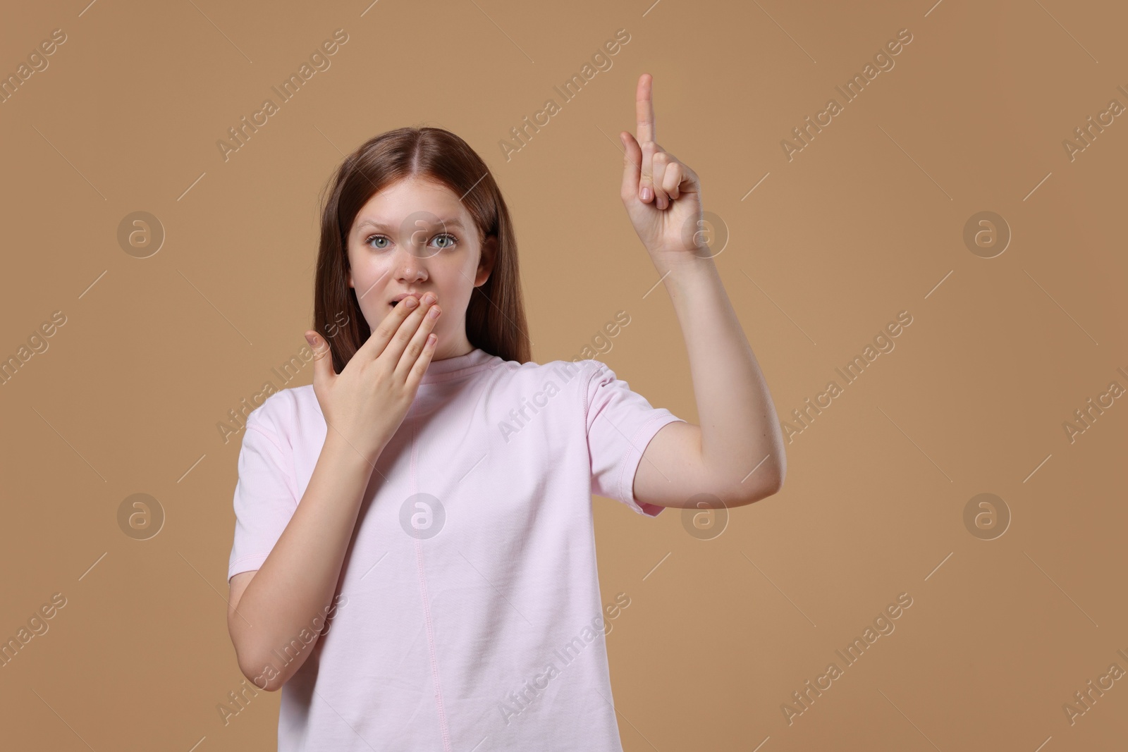 Photo of Portrait of teenage girl on beige background, space for text