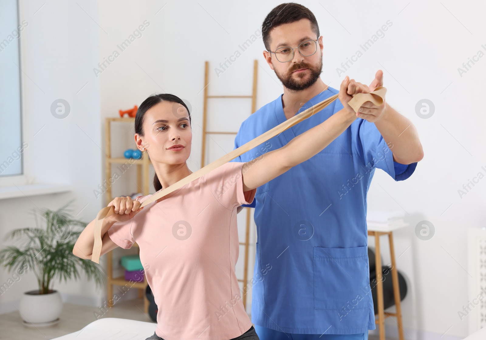 Photo of Physiotherapist working with patient in rehabilitation center