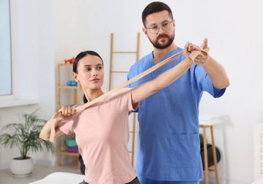 Physiotherapist working with patient in rehabilitation center