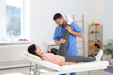 Physiotherapist working with patient in rehabilitation center