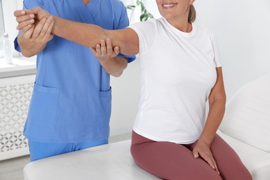 Photo of Physiotherapist working with senior patient in rehabilitation center, closeup